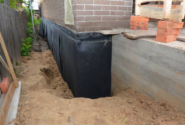 Happy homeowners after waterproofing job in Clements